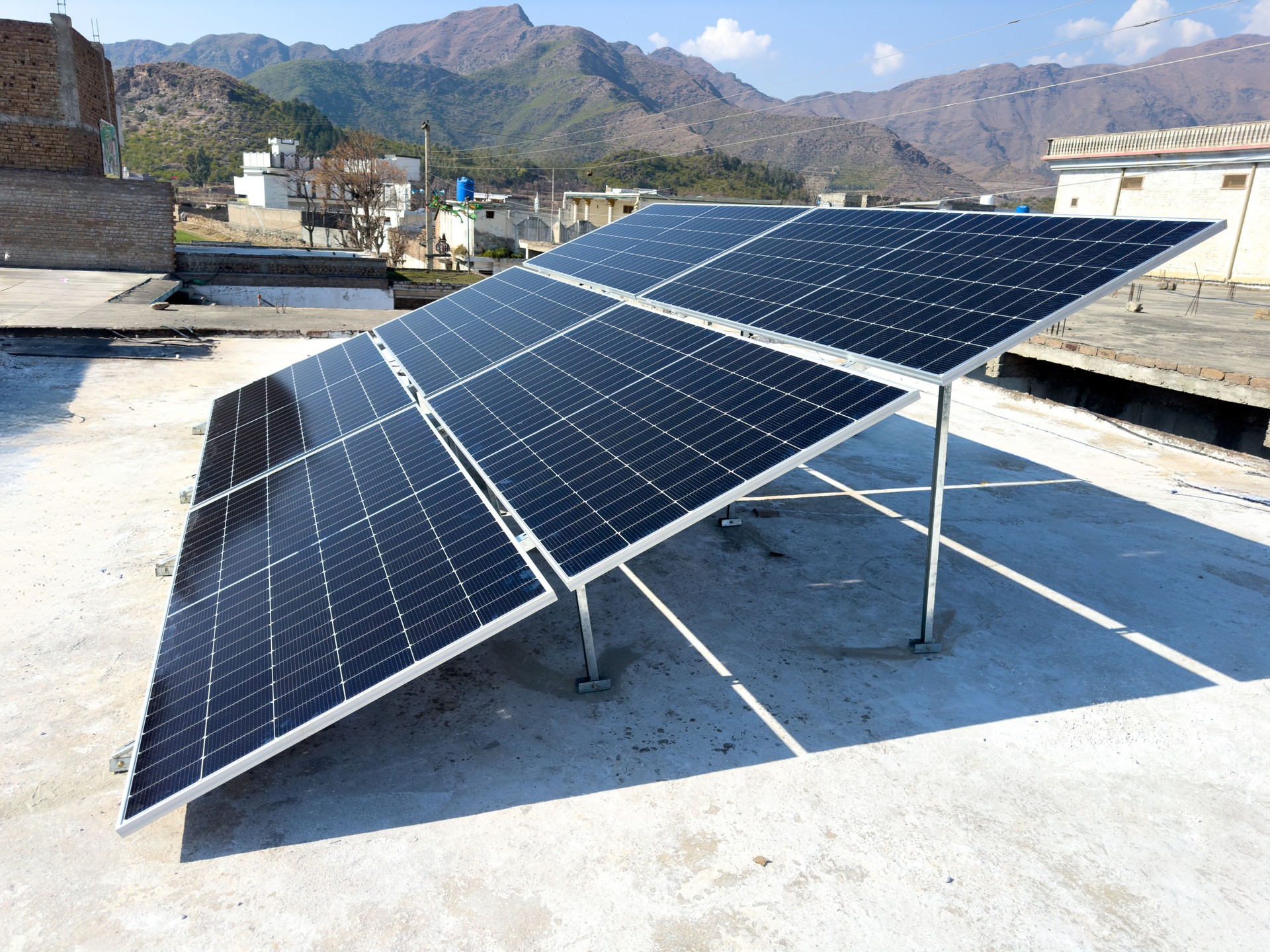 Solar panels on a house roof in Pakistan by generating clean and renewable energy.